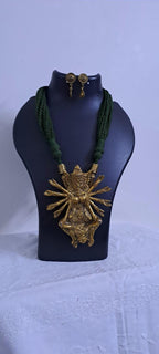 Green thread necklace with oxidised golden durga pendant