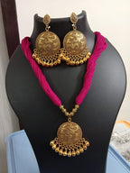 Red thread necklace with golden oxidised traditional pendant