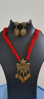 Red thread necklace with golden oxidised traditional pendant