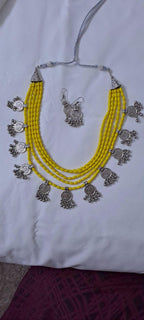 Exclusive multi layered  yellow glass beads necklace set with silver oxidised charms n matching earrings
