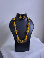 Yellow thread necklace with trinkets n matching earrings