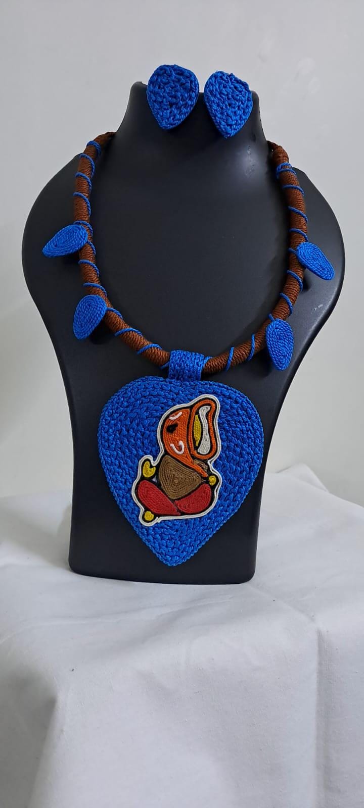 Exclusive brown and blue thread necklace with leaf shaped  Ganesha thread pendant and matching earrings.