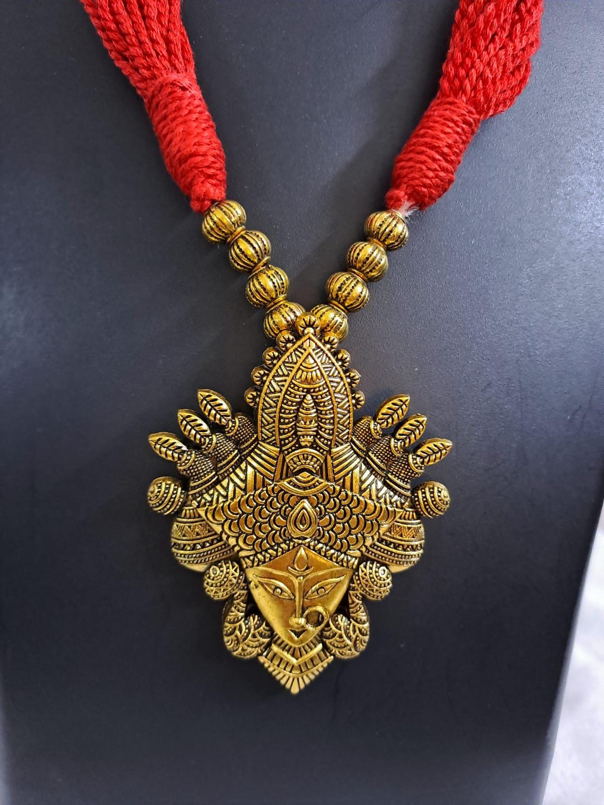 Red thread jewellery set with golden durga pendant n matching earrings