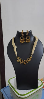 Off white thread necklace with Golden oxidised traditional pendant