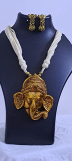 Off-white thread necklace with golden oxidised ganesha pendant