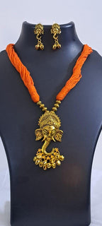 Orange thread necklace with Golden oxidised traditional pendant