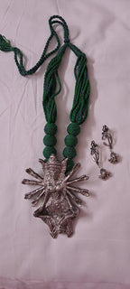 Green thread necklace with oxidised golden durga pendant