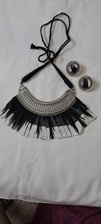 Exclusive necklace with silver oxidised big oval pendant with fabric fringes and matching earrings.