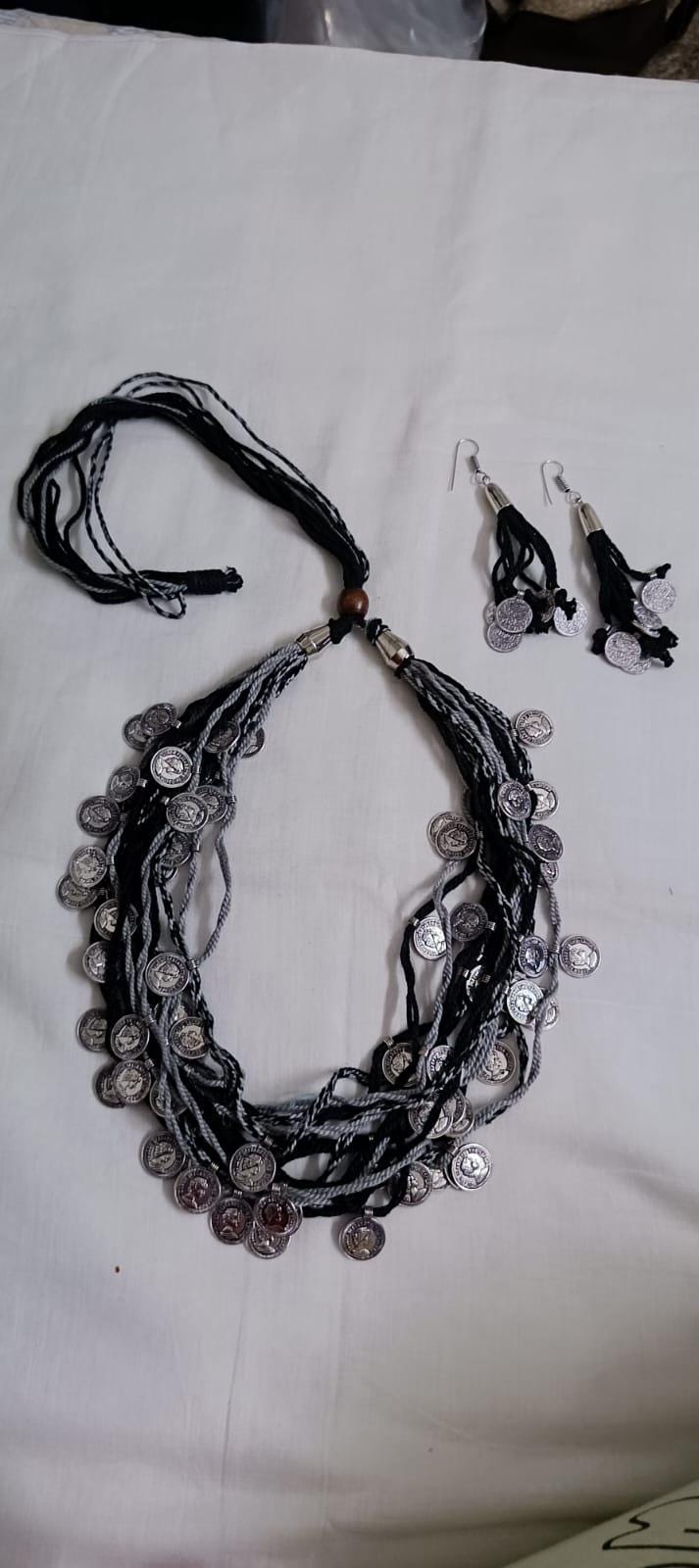Exclusive multi-coloured and multi-layered thread necklace with silver oxidised charms