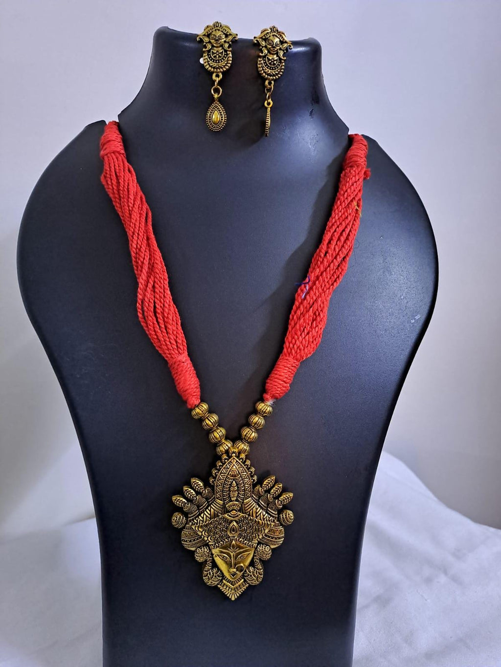 Red thread jewellery set with golden durga pendant n matching earrings