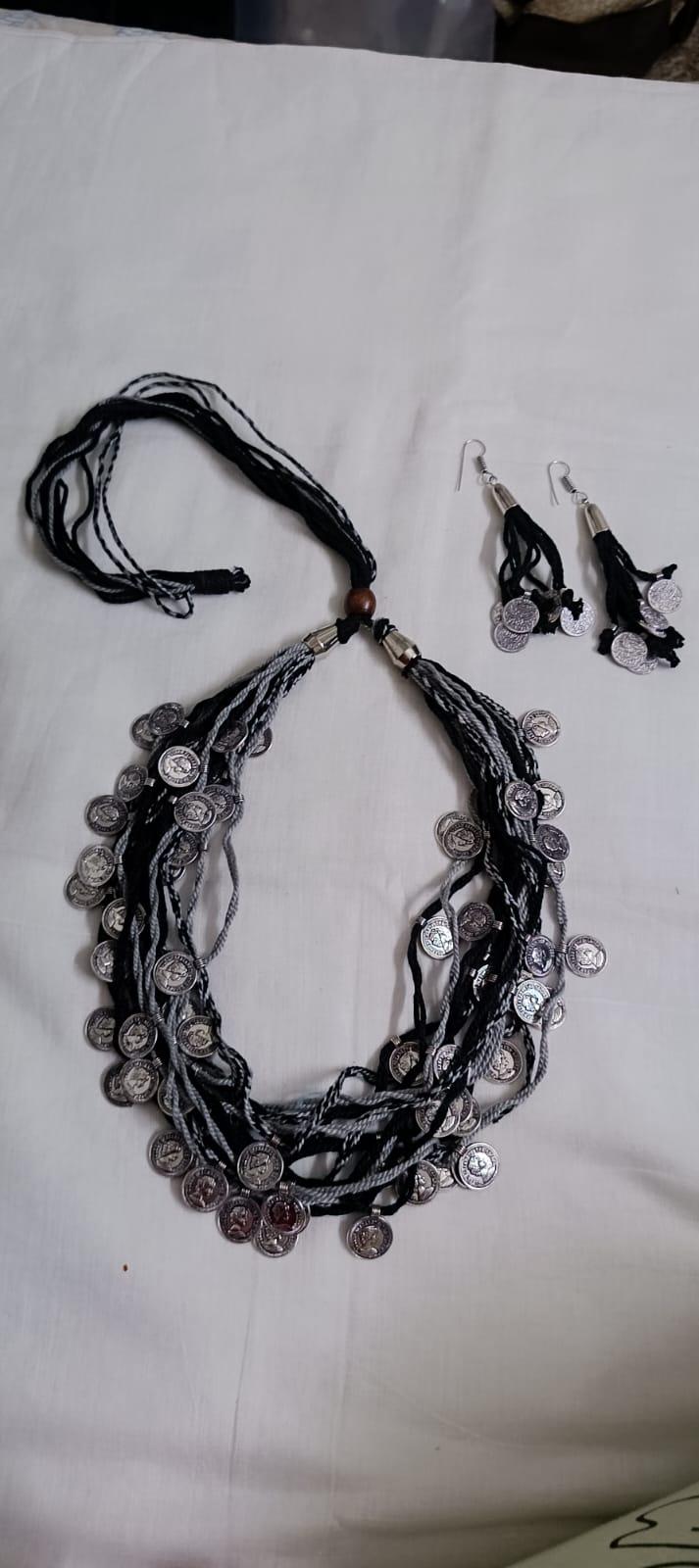 Exclusive multi-coloured and multi-layered thread necklace with silver oxidised charms