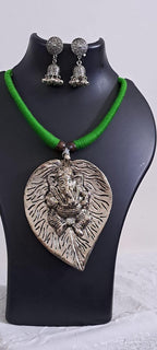 Green thread necklace with silver oxidised ganesha pendant
