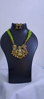 Light green thread necklace with Golden oxidised traditional pendant