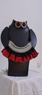 Exclusive necklace with silver oxidised big oval pendant with fabric fringes and matching earrings.