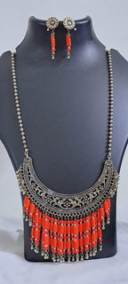 Exclusive necklace with silver oxidised big oval pendant with glass beads fringes and matching earrings.