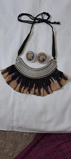 Exclusive necklace with silver oxidised big oval pendant with fabric fringes and matching earrings.