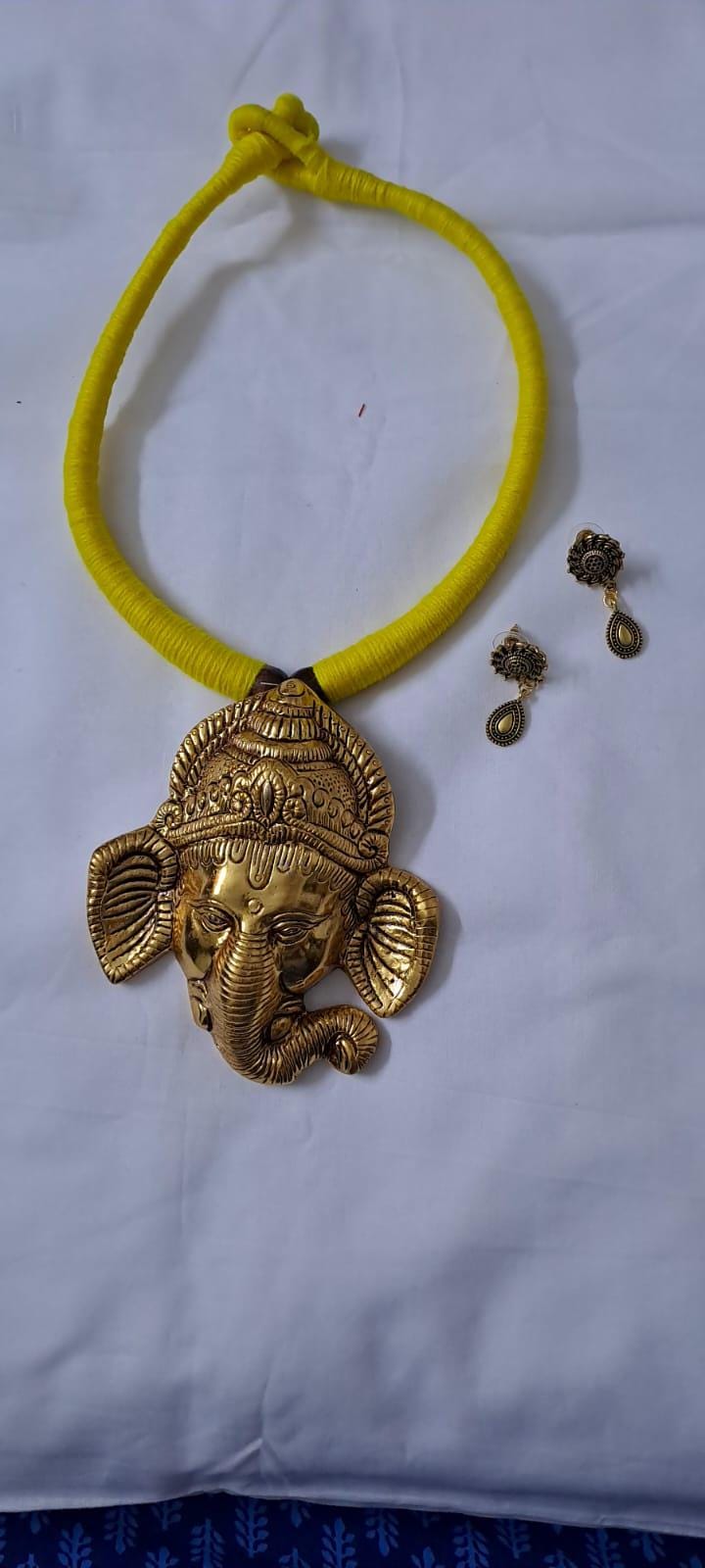 Yellow thread necklace with golden oxidised ganesha pendant