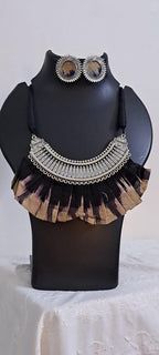 Exclusive necklace with silver oxidised big oval pendant with fabric fringes and matching earrings.