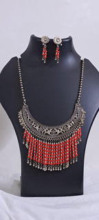 Exclusive necklace with silver oxidised big oval pendant with glass beads fringes and matching earrings.