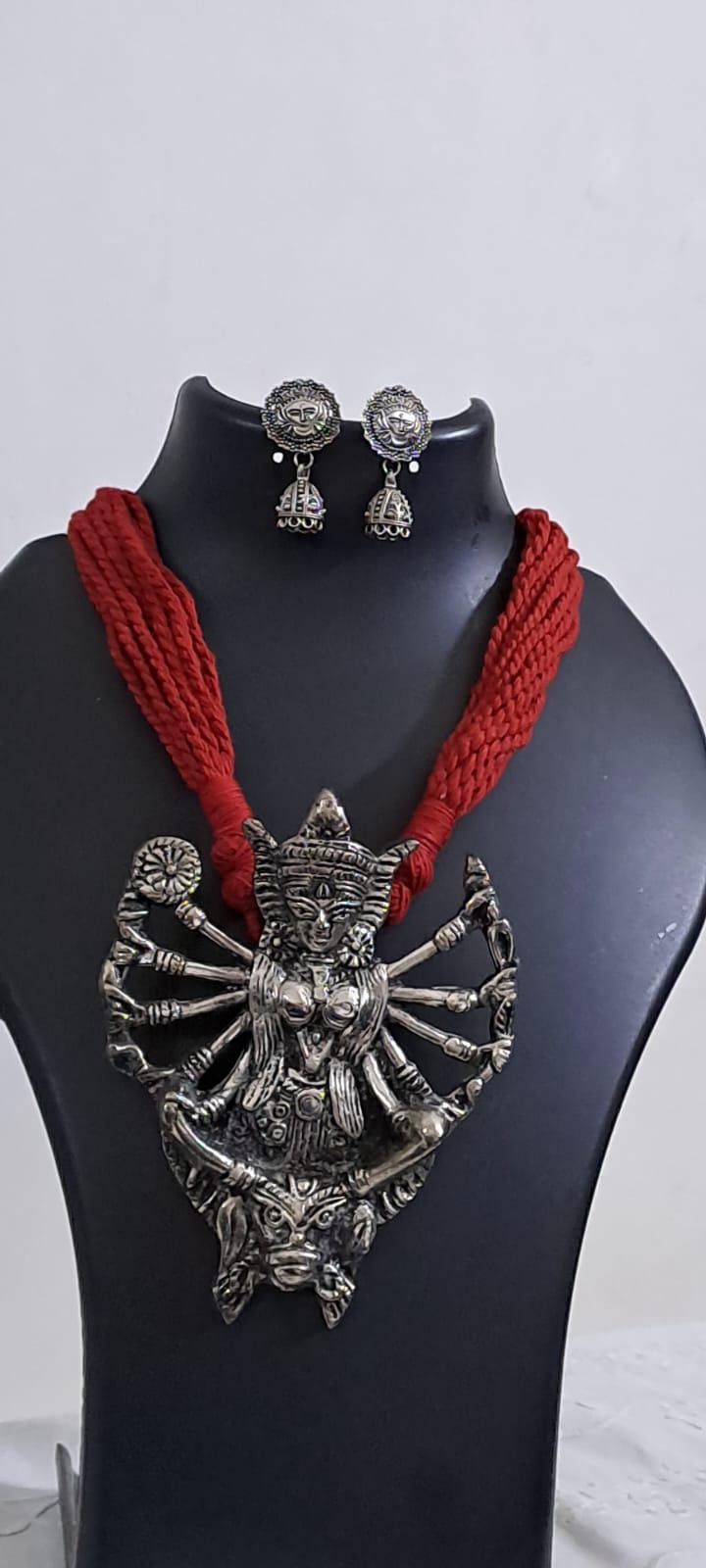 Red thread necklace with oxidised silver durga pendant