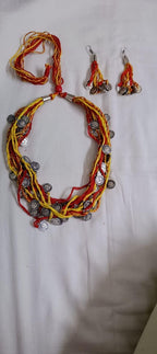 Exclusive multi-coloured and multi-layered thread necklace with silver oxidised charms