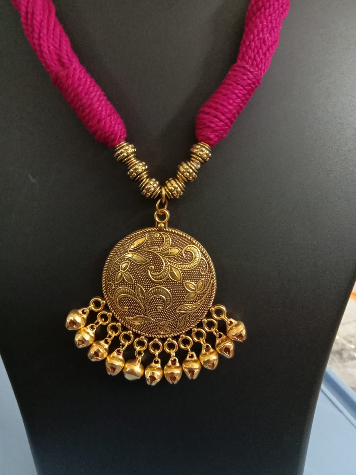 Red thread necklace with golden oxidised traditional pendant