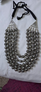Multi-layered silver oxidised beads necklace .