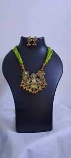 Light green thread necklace with Golden oxidised traditional pendant