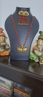 Red beads necklace with golden oxidised pendant