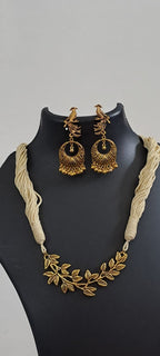 Off white thread necklace with Golden oxidised traditional pendant