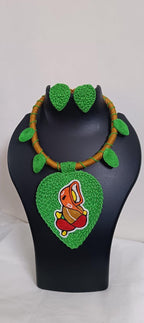 Exclusive light green and brown  thread necklace with leaf shaped  Ganesha pendant  and matching earrings.