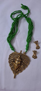 Green thread necklace with golden oxidised ganesha pendant