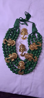 Multilayered fabric beads set with golden oxidised goddess Durga pendants - Dark Green