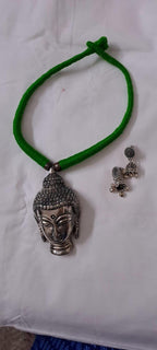 Green thread necklace with silver oxidised buddha pendant