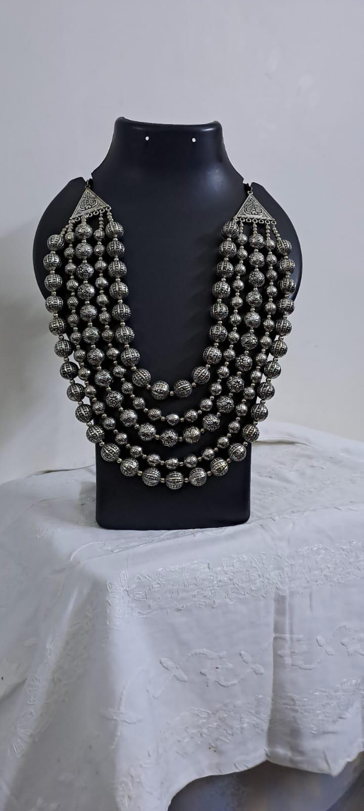 Multi-layered silver oxidised beads necklace .