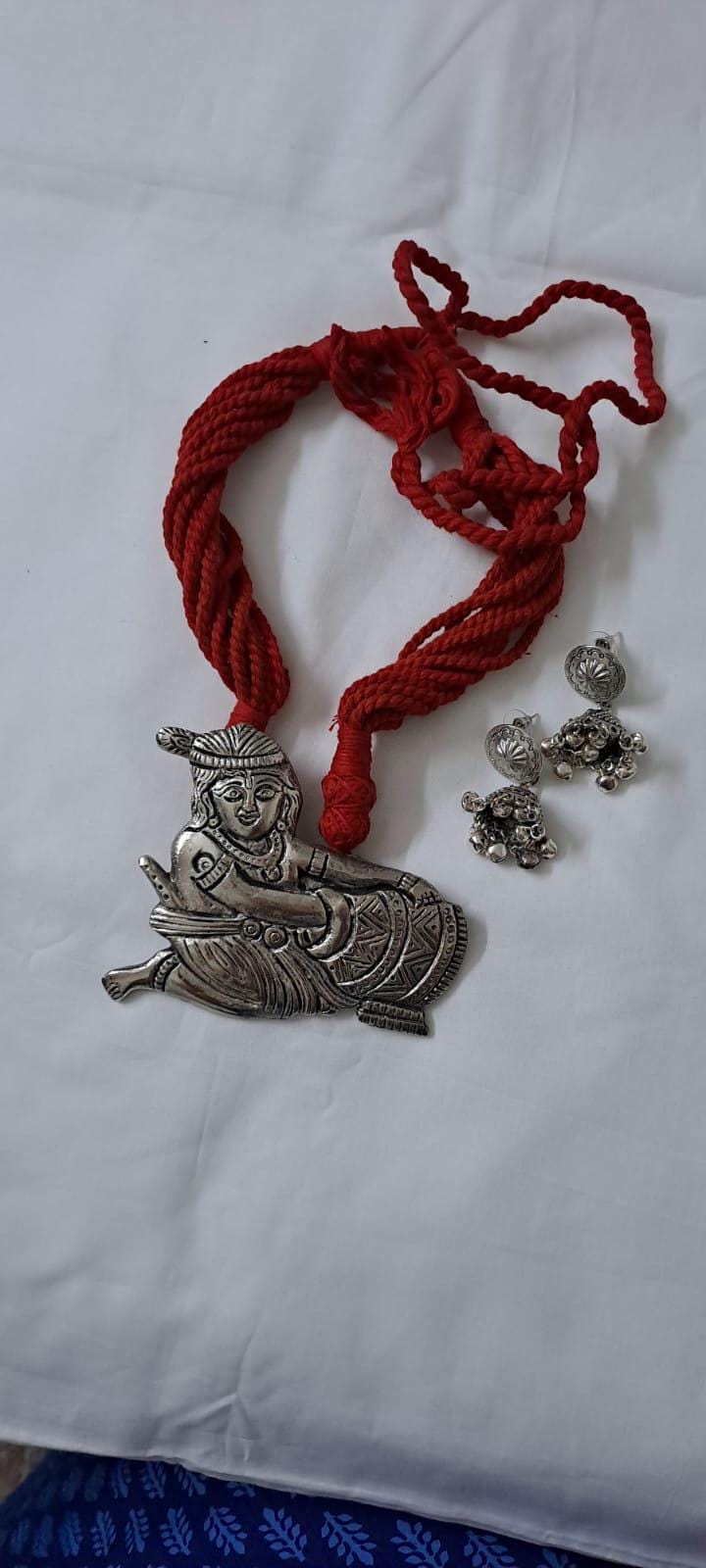 Red thread necklace with silver oxidised krishna pendant