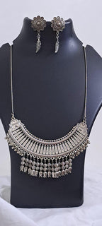 Exclusive necklace with silver oxidised big oval pendant with beads fringes and matching earrings.