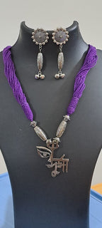 Purple thread necklace with oxidised silver durga pendant