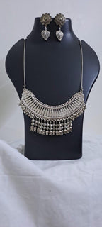 Exclusive necklace with silver oxidised big oval pendant with beads fringes and matching earrings.