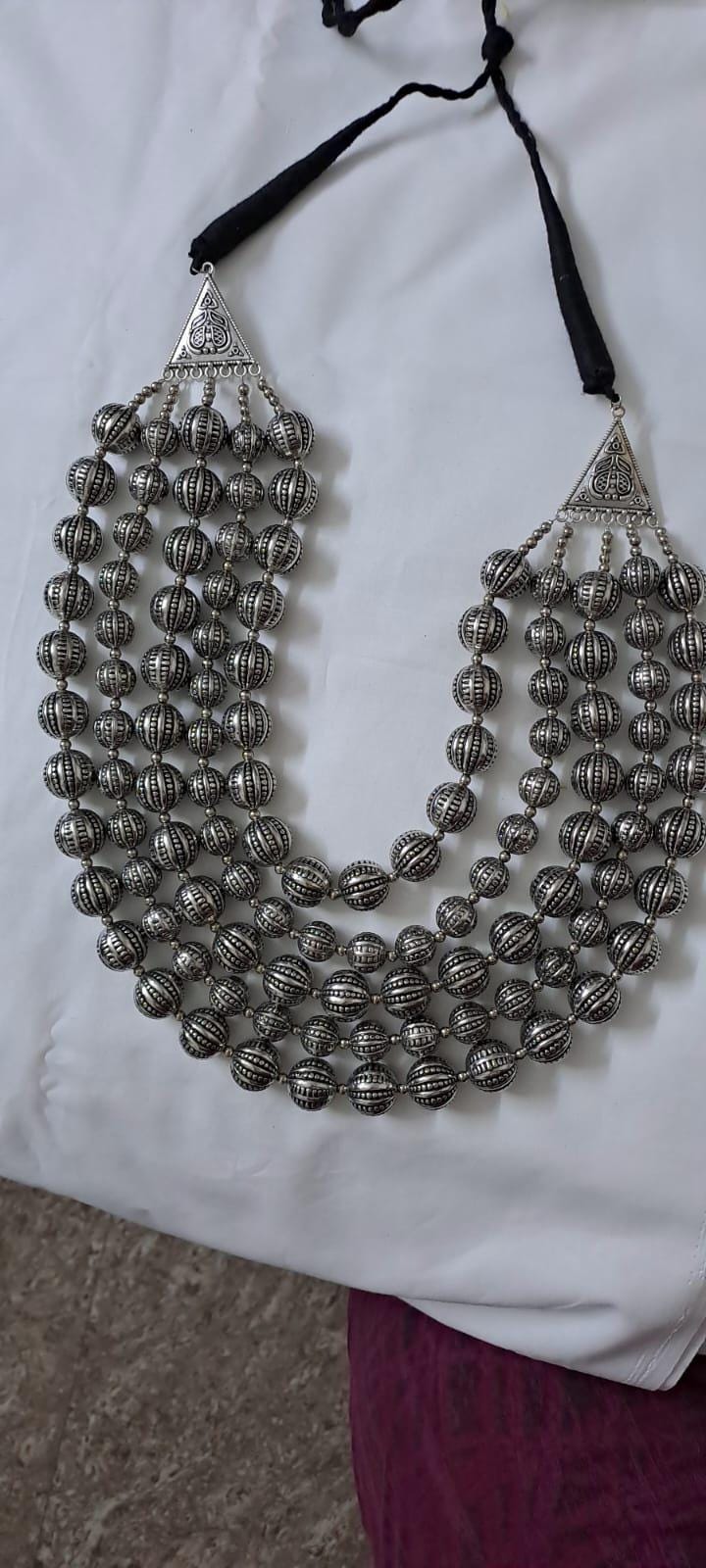 Multi-layered silver oxidised beads necklace .