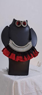 Exclusive necklace with silver oxidised big oval pendant with fabric fringes and matching earrings.