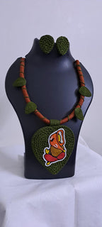 Exclusive forest green and brown thread necklace with leaf shaped  Ganesha thread pendant and matching earrings.