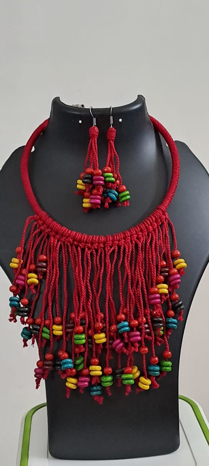 Exclusive red thread neckband with fringes and matching earrings.