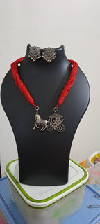 Red thread necklace with silver oxidised traditional pendant