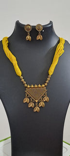 Yellow thread necklace with golden oxidised traditional pendant