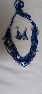 Exclusive multi-coloured and multi-layered thread necklace with silver oxidised charms