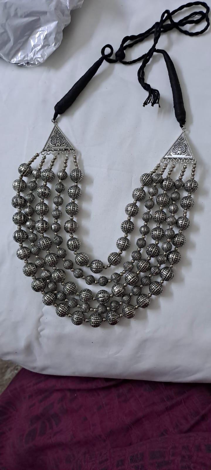 Multi-layered silver oxidised beads necklace .