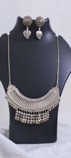 Exclusive necklace with silver oxidised big oval pendant with beads fringes and matching earrings.
