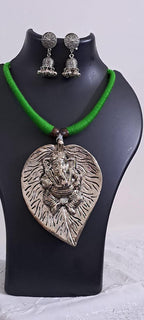 Green thread necklace with silver oxidised ganesha pendant