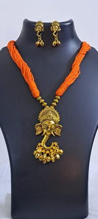 Orange thread necklace with Golden oxidised traditional pendant